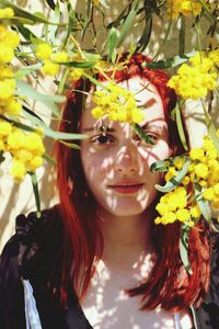 Close-up portrait of a young woman with flowers