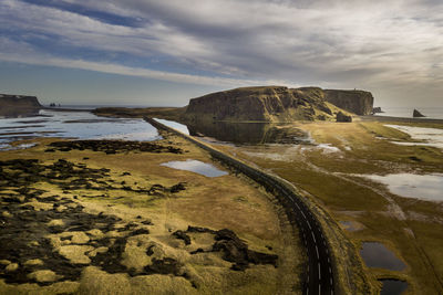 Aerial view of a car on a scenic road near vik, iceland