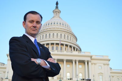 Portrait of man standing in front of building