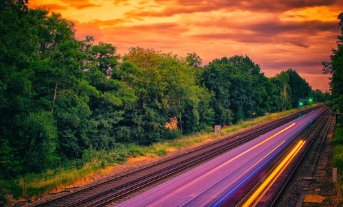 Light trails on road against sky