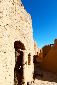 Shadow of old building against blue sky