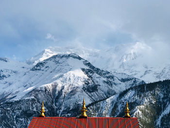 Scenic view of snowcapped mountains against sky