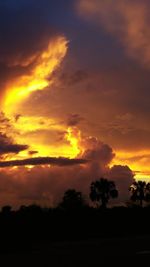 Scenic view of dramatic sky over silhouette landscape