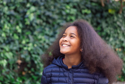 Portrait of a smiling young woman looking away