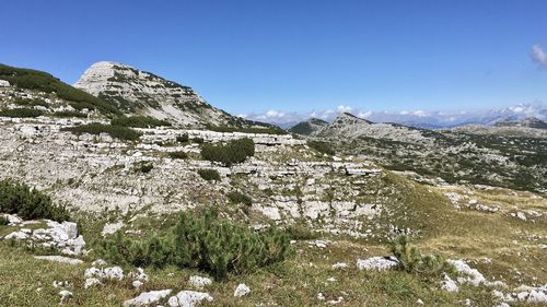 Scenic view of snowcapped mountains against blue sky