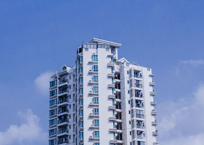 Low angle view of buildings against blue sky