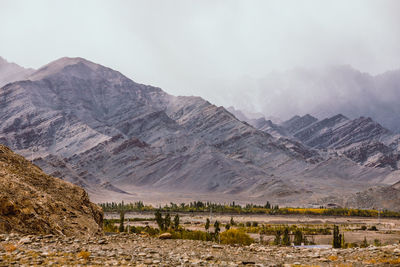 Scenic view of landscape and mountains against sky