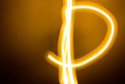 Close-up of illuminated light candles against black background