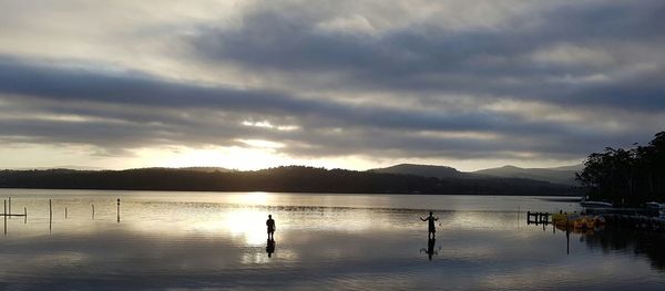 Scenic view of lake against dramatic sky