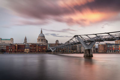 View of bridge over river against cloudy sky