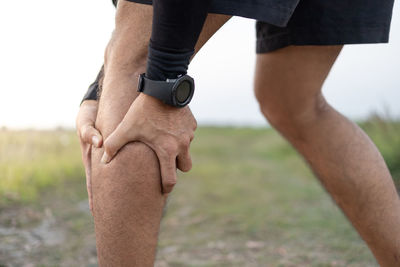 Midsection of man standing on land