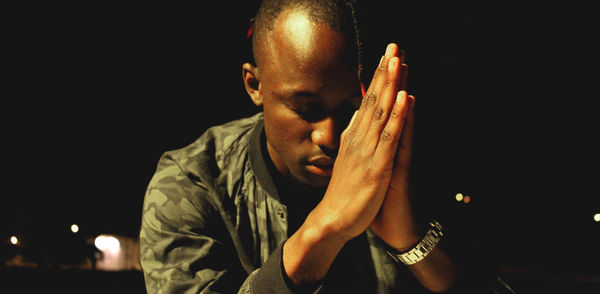 Close-up of hand against black background