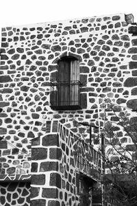 Low angle view of window on wall of old building