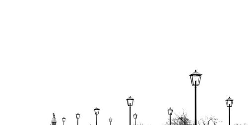 Low angle view of street lights against clear sky