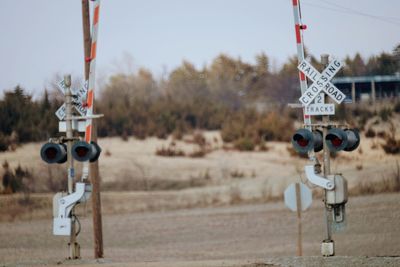 Railroad crossing sign by field