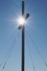 Low angle view of street light against blue sky