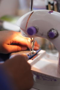 Close-up of person working in machine