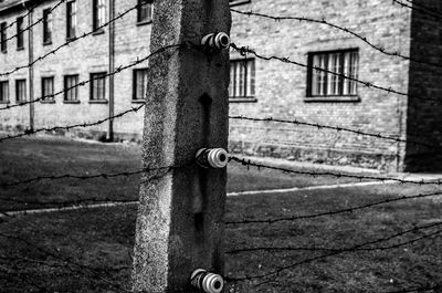 Close-up of padlock on gate against building