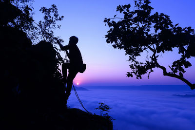 Low angle view of silhouette man against sky