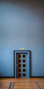 Closed door by blue wall