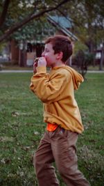 Side view of boy playing in park