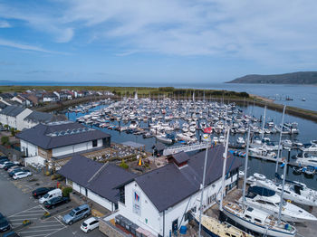 High angle view of townscape by sea against sky