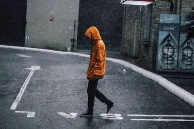 Full length of man walking on road in city