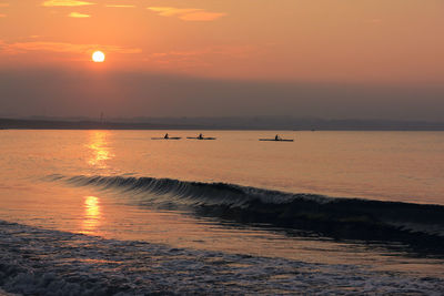 Scenic view of sea against orange sky