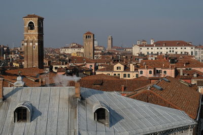 View of buildings in city against clear sky