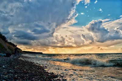 Scenic view of beach against sky during sunset