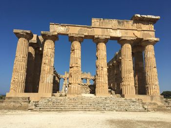 Old ruins of temple against clear sky