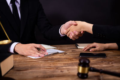 Midsection of people on table