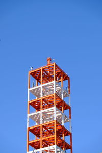 Low angle view of tower against blue sky