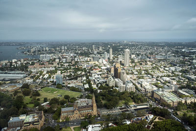 High angle view of cityscape against cloudy sky