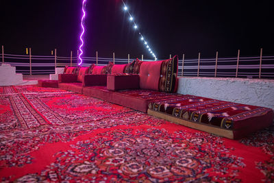 Low angle view of illuminated lights against sky at night