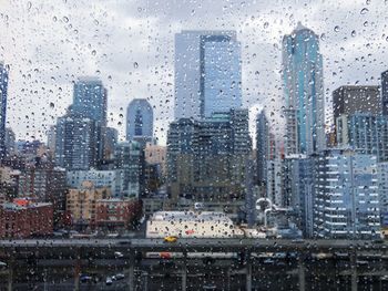 Cityscape seen through wet window during rainy season