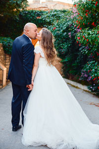 Rear view of couple holding hands