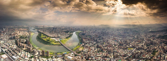 High angle view of city against cloudy sky