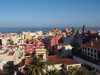 High angle view of town against blue sky