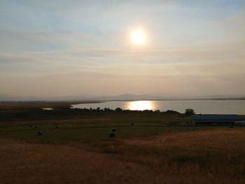 Scenic view of field against sky during sunset