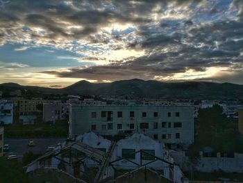 High angle shot of townscape against cloudy sky
