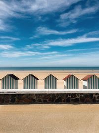 Built structure on beach against blue sky