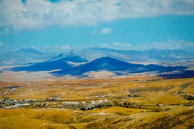 Scenic view of landscape and mountains against sky