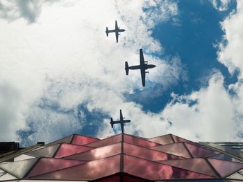 Low angle view of airplane flying against sky