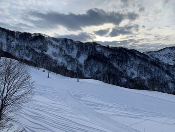 Scenic view of snow covered mountains against sky