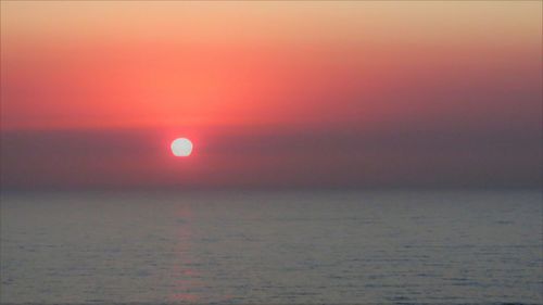 Scenic view of sea against sky at sunset