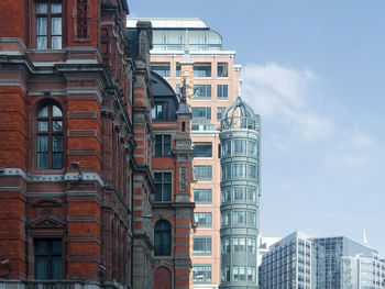 Low angle view of buildings in city against sky