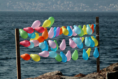 Close-up of multi colored balloons on beach
