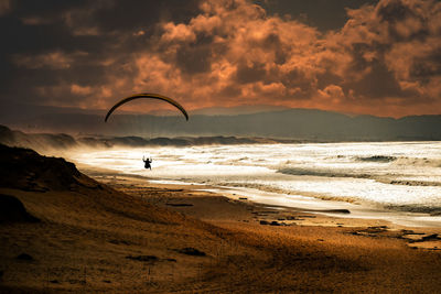 Scenic view of beach against sky during sunset