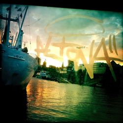 Nautical vessel in sea at sunset